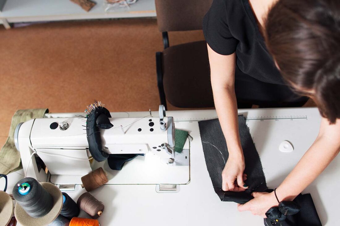 Seamstress creates a sketch on  the fabric. designer sews clothes