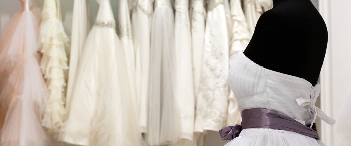 The range of wedding dresses on hangers and on a mannequin in the showroom